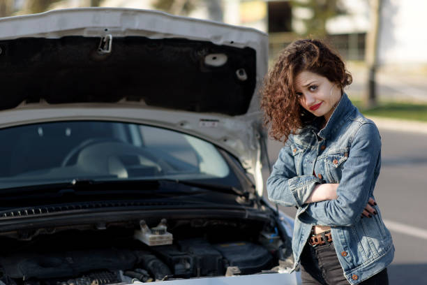 istock Unhappy woman with a broken car 1134671603