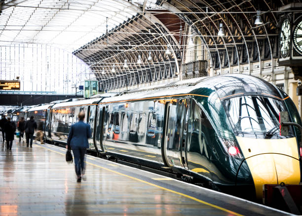 Train Station Platform Motion blurred anonymous people walking inside large railway terminus platform train stations stock pictures, royalty-free photos & images