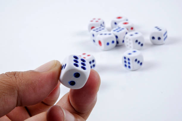 istock Close-Up Of Hand Holding Dice Over Gray Background 1134673909