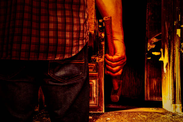 istock evil man with a hammer in a spooky house 1134674828