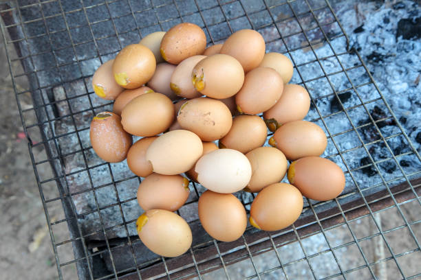 Thai street food, Special grilled eggs,  Steamed egg with seasonnings on charcoal stove
