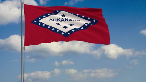 istock Flag of Arkansas - US state fluttering in the wind against a cloudy sky 3d rendering 1134676856