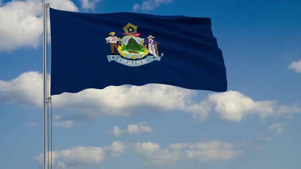 istock Flag of Maine - US state fluttering in the wind against a cloudy sky 3d rendering 1134676863