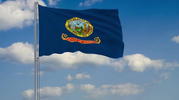 istock Flag of Idaho - US state fluttering in the wind against a cloudy sky 3d rendering 1134676908