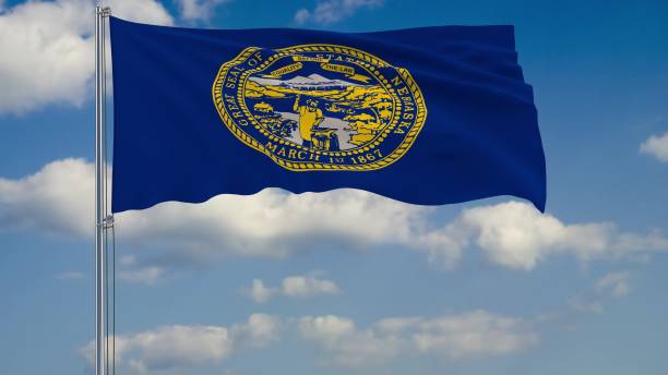 istock Flag of Nebraska - US state fluttering in the wind against a cloudy sky 3d rendering 1134676977