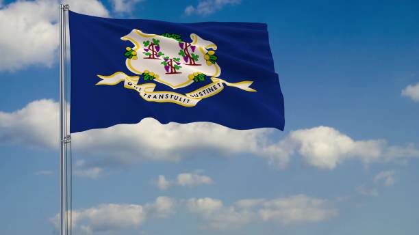 istock Flag of Connecticut - US state fluttering in the wind against a cloudy sky 3d rendering 1134676984