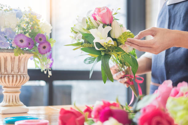 istock Midsection Of Person Holding Flowers 1134678430