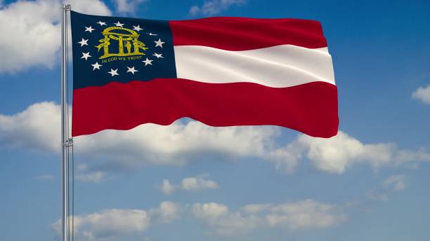 istock Flag of Georgia - US state fluttering in the wind against a cloudy sky 3d rendering 1134680149
