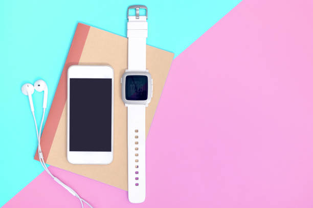 istock Empty mobile phone with smartwatch gadgets on blue pink 1134680743