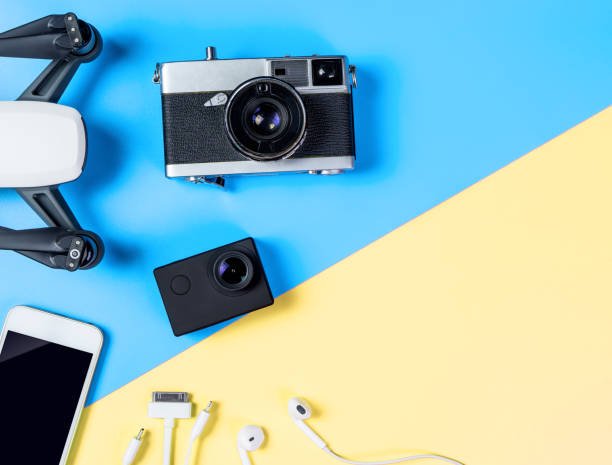 istock Hi tech travel gadget and accessories on blue and yellow copy space 1134680812