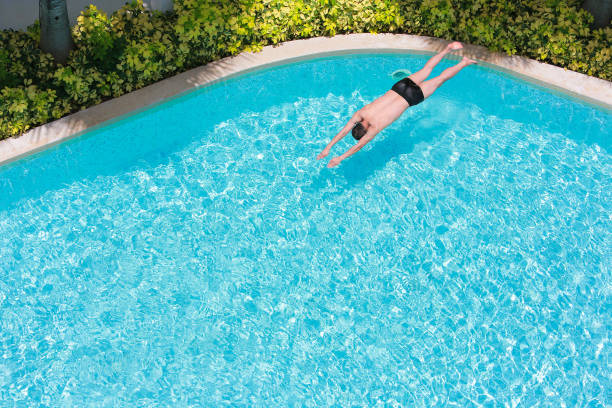 istock High Angle View Of Man Diving In Swimming Pool 1134682604