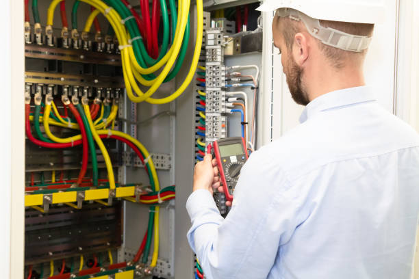 istock Electrician engineer with measuring tool works in electrical cabinet 1134685999