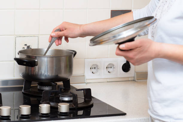 istock Wife prepares her husband for dinner in the kitchen 1134686688