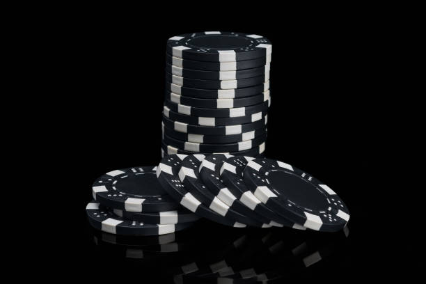 istock heap of black poker chips reflected in black background 1134688604