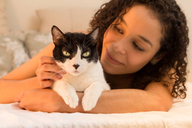 istock Woman With Cat Lying On Bed At Home 1134689915