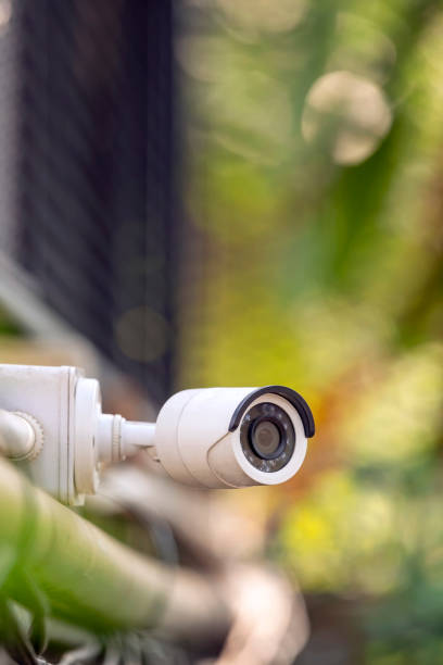 istock A white CCTV on the fence with green blur background 1134691395
