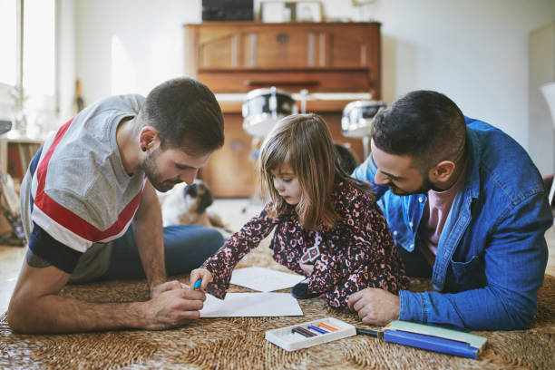 istock Males assisting daughter in drawing at home 1134694518