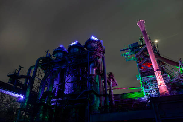 istock Old factory buildings illuminated at night 1134698363