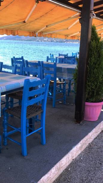 istock Scenic view on Mediterranean sea from Greek restaurant with blue chairs 1134699415