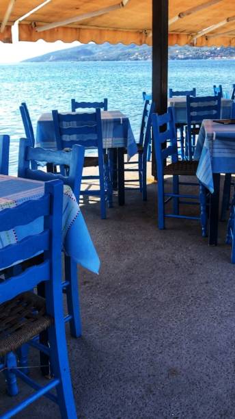 istock Scenic view on Mediterranean sea from Greek restaurant with blue chairs 1134699416