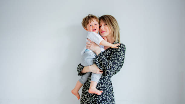 istock Mother and son on a white wall background at home 1134700748