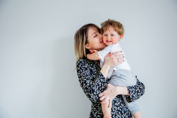 istock Mother and son on a white wall background at home 1134700754