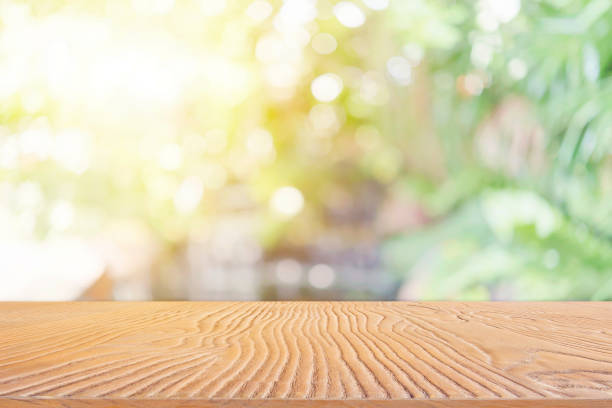 istock Abstract background from wooden table top with blurred nature with backlight. 1134703223