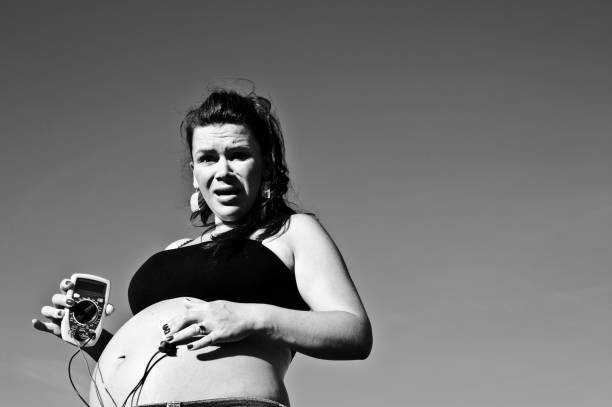 istock Beautiful pregnant woman posing outdoors with a detector. Black and white image 1134703400