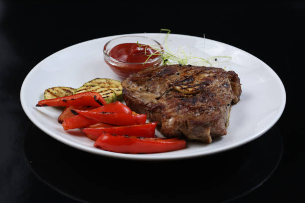 istock Beef kebabs on a plate with grilled vegetables, zucchini and Bulgarian red pepper, decorated with greens 1134706903