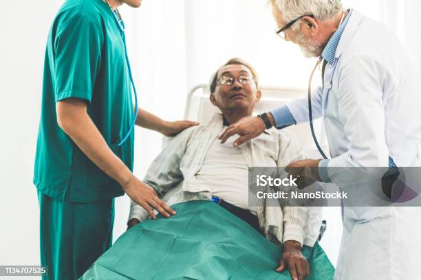 Mature Doctor Talking And Examining Health Of Senior Patient In Hospital Ward Medical Healthcare And Doctor Staff Service Concept Stock Photo - Download Image Now