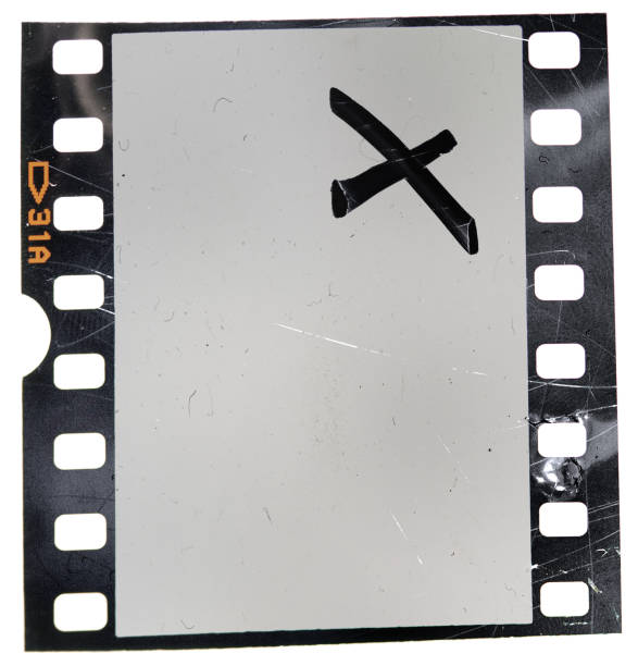 real 35mm film with scratches old 35mm film strip on white background 35mm movie camera stock pictures, royalty-free photos & images