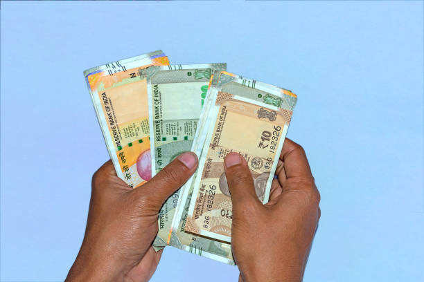 istock Man's hands holding Multiple type new Indian currency on white background. 1134710666
