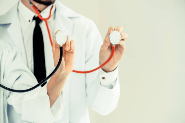 istock Close up shot of two doctors pointing stethoscope at copy space. Selective focus at front doctors hand. 1134711221