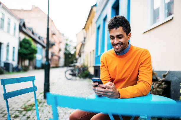 istock Brazilian / Latinx millennial man using mobile phone 1134712752