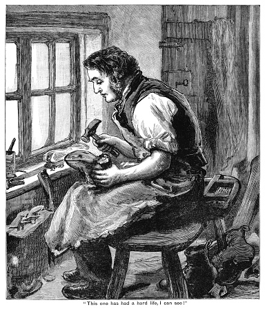 A 19th century cobbler sitting by the window of his workshop, examining a heavily worn boot with his tools at the ready. From “The Cottager and Artisan 1890”. Published by The Religious Tract Society, London.