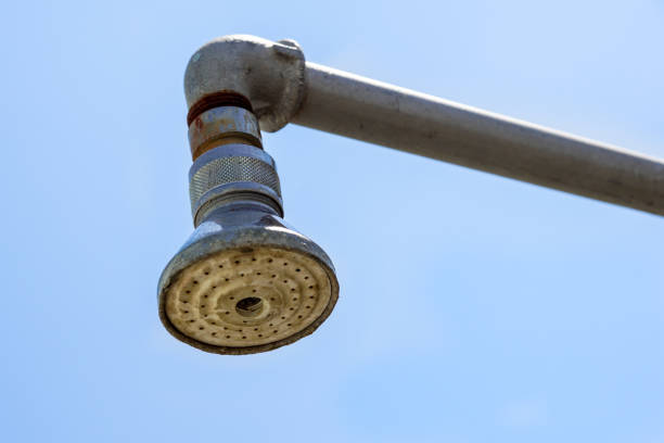 Hard water deposit and rust on shower tap