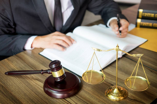 istock Midsection Of Lawyer Writing On Book At Table 1134720442