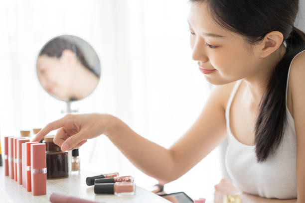 istock woman choosing lipstick for make up 1134721468