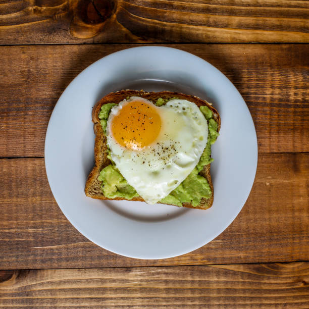 istock Toast with avocado and egg with heart shape  on white plate 1134723660