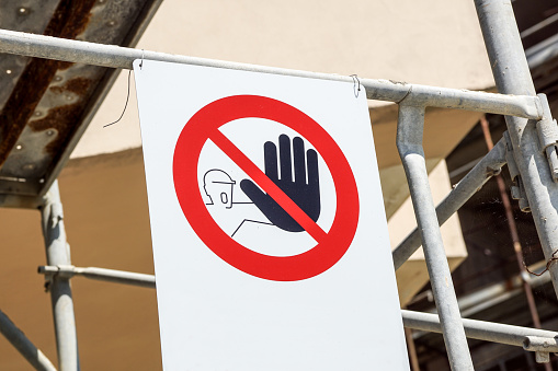 No entry sign on the fence in contruction site with house under construction