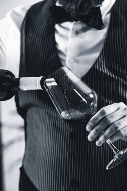 istock Midsection Of Bartendar Pouring Wine In Glass 1134726837
