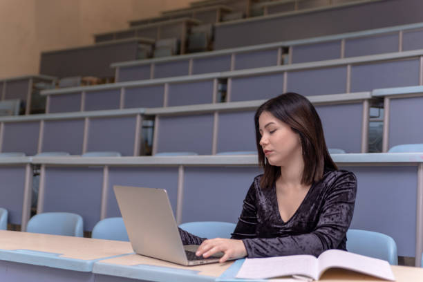 istock Woman working on laptop in a classroom 1134729174
