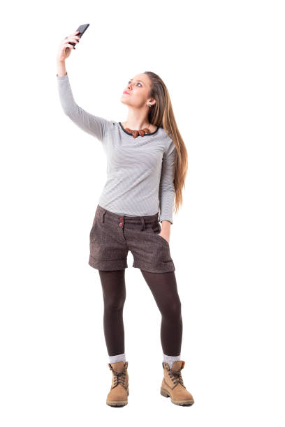 istock Stylish young woman in hipster look clothes taking selfie photo with mobile phone 1134731417