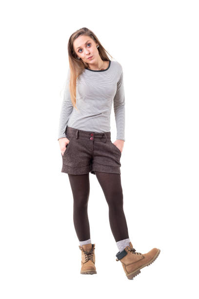 istock Cool young blonde woman cutie whistling with hands in pockets 1134731707