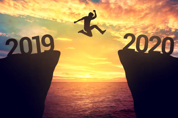 Businessman jump between 2019 and 2020 years. Businessman jump between 2019 and 2020 years. 2019 photos stock pictures, royalty-free photos & images