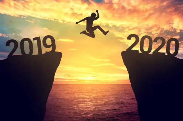 Photo of Businessman jump between 2019 and 2020 years.