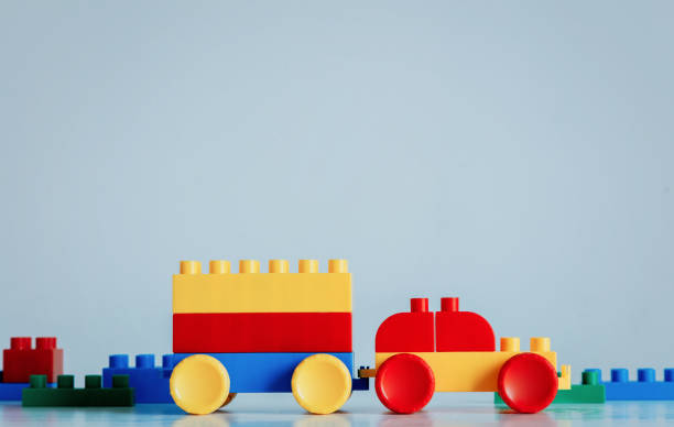 istock Plastic bricks car in yellow and red colors with trailer 1134741385