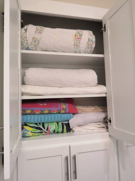 istock linen cabinet open in bathroom, shows towels, bedding 1134743700