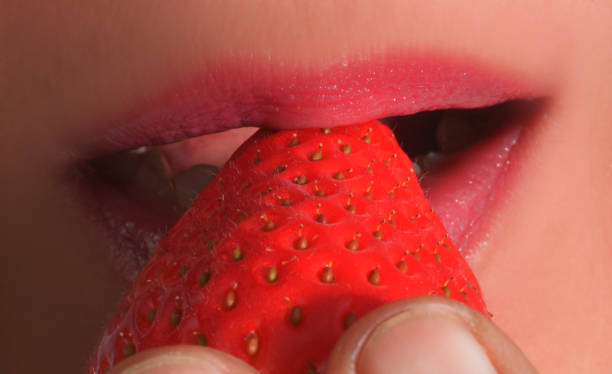 istock Strawberry in a woman's mouth 1134745728
