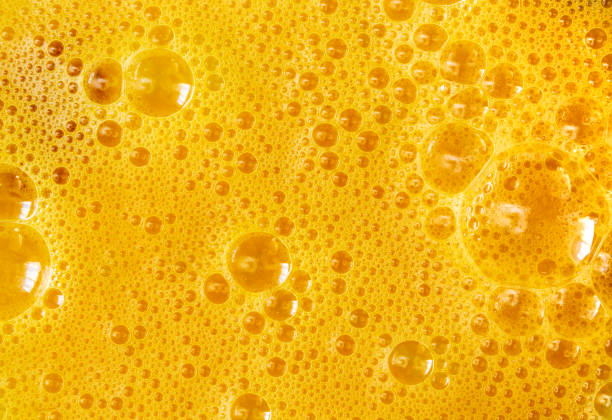 istock Yellow background of beaten chicken eggs with bubbles texture. 1134747958
